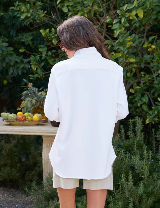 The FRANK & EILEEN Eileen Relaxed Button Up in Triple Fleece White features long sleeves, a single chest pocket, rolled cuffs, and a curved hem, shown against a white background.