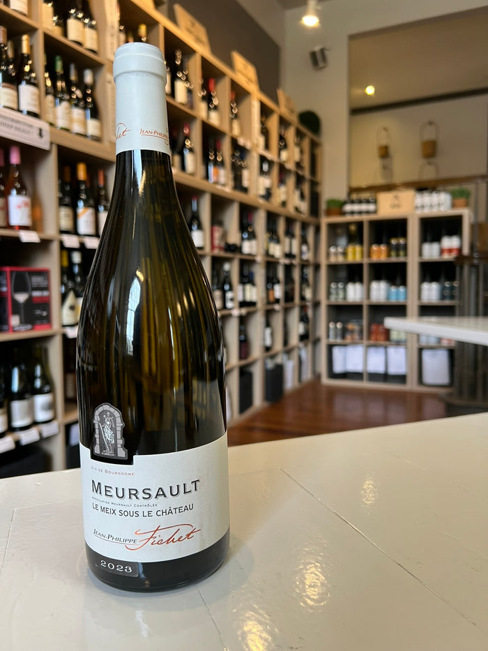 A bottle of JEAN-PHILIPPE FICHET ‘LE MEIX SOUS CHÂTEAU’ MEURSAULT 2023 from WINE: ADVINTAGE, a Burgundy white wine with a white top and clean white label featuring stylish black and red text.