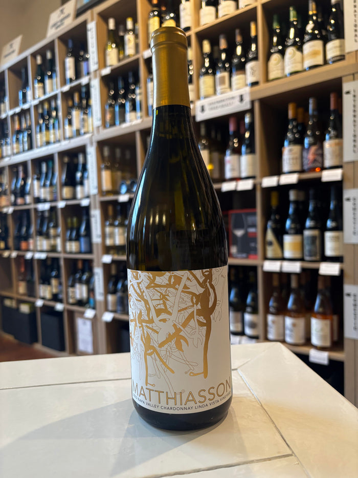 A certified organic MATTHIASSON ‘Linda Vista Vineyard’ Chardonnay 2023 by Wine: Proof, with a gold foil neck and an abstract gold and white label displaying "Matthiasson" at the bottom.