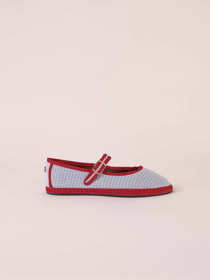 The SVETI STEFAN - MARY JANE SHOE by SVETI STEFAN is a light blue cotton flat with a textured surface, red trim, gel insole, and silver buckle strap, shown against a plain light background.