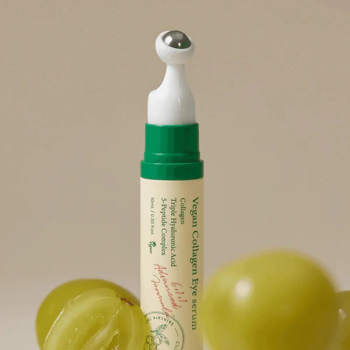 Axis-Y Vegan Collagen Eye Serum tube next to green grapes.