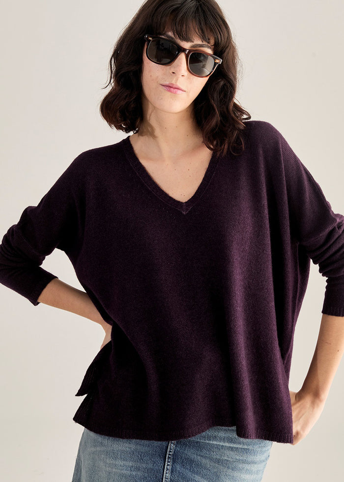 Close-up of a warm, rusty orange knitted fabric showcasing the even stockinette stitch texture of the BASE MILANO - BOXY OVERSIZED V NECK SWEATER by BASE MILANO.