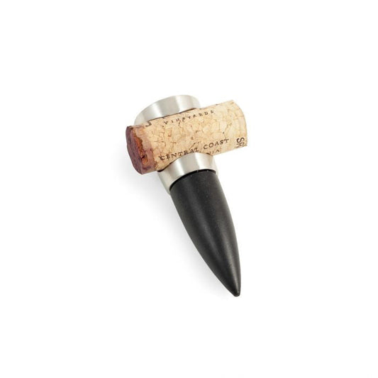 The BEYBERK INTERNATIONAL BOTTLE STOPPER AND CORK HOLDER features a brushed nickel finish, cork top with printed text, and a tapered black bottom—making it a stylish wine gift on any white background.