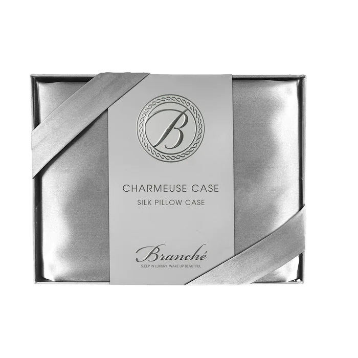 The BRANCHE - CHARMEUSE PILLOW CASE SILK comes boxed with a gray label and pink ribbon, stating “BRANCHE Sleep Luxury. Wake Up Beautiful.” Designed to reduce hair frizz and prevent wrinkles.