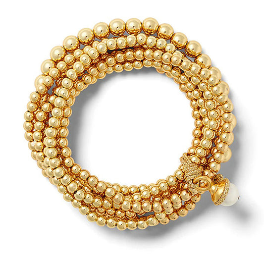 The Sally Bracelet by CC & CO features multiple rows of shimmering 14 karat gold beads with an ornate clasp and a single white bead, forming an elegant circular pattern against a white background.