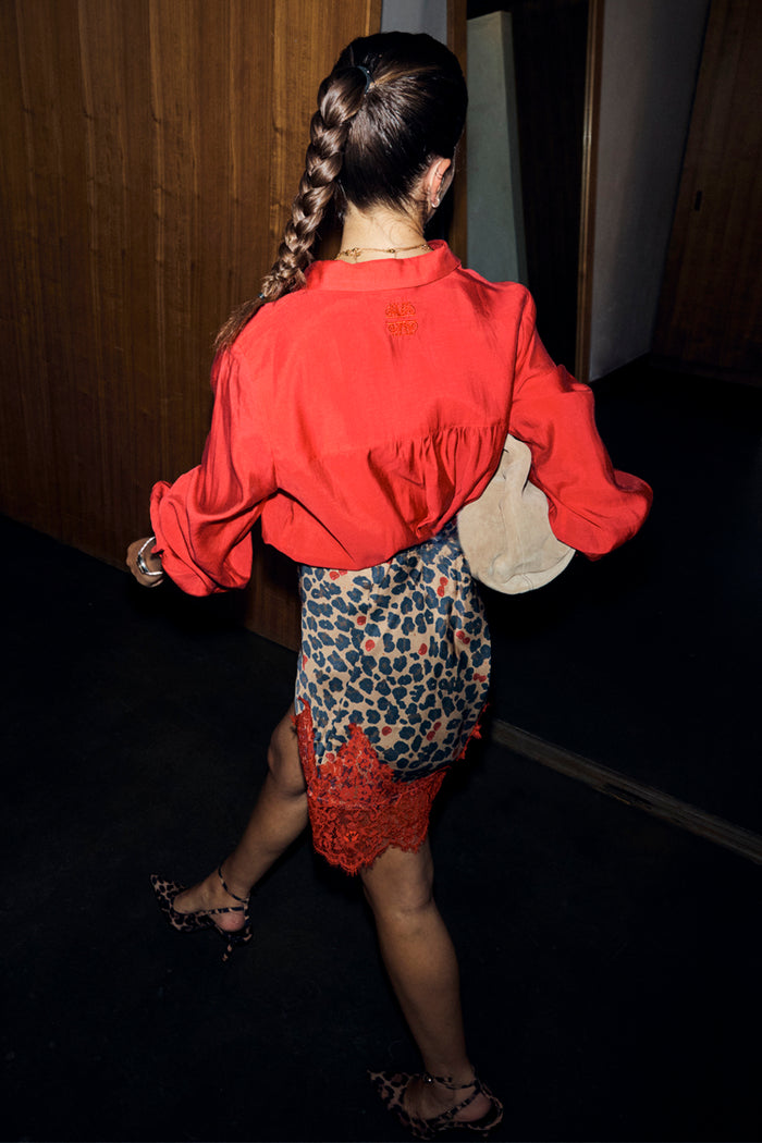 Cherry Red Miley Shirt featuring blouson sleeves and back neck embroidery, styled with a leopard print lace trim skirt.