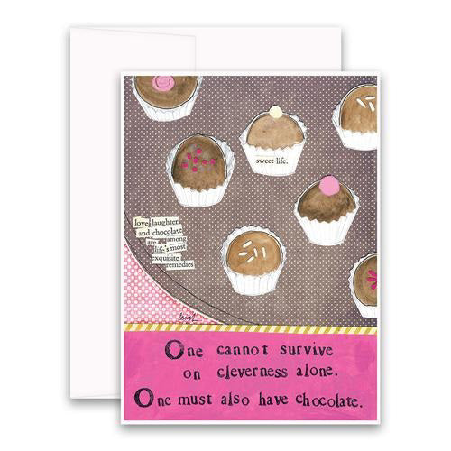 The CURLY GIRL DESIGNS - CLEVERNESS ALONE GREETING CARD by CURLY GIRL DESIGN, INC features assorted chocolates on a brown and pink background with the message: "One cannot survive on cleverness alone. One must also have chocolate—one of life’s remedies.