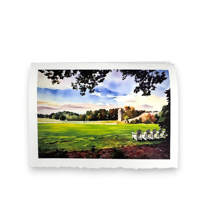 The FEARRINGTON SIGNATURE COLLECTION "CALM AFTER STORM" watercolor greeting card by PICTURE SALON captures a green lawn, silo, and white Adirondack chairs under leafy branches and blue sky—ideal for premium cardstock cards.