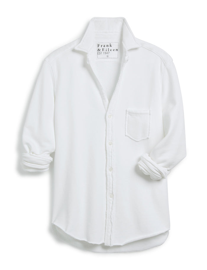 The FRANK & EILEEN Eileen Relaxed Button Up in Triple Fleece White features long sleeves, a single chest pocket, rolled cuffs, and a curved hem, shown against a white background.