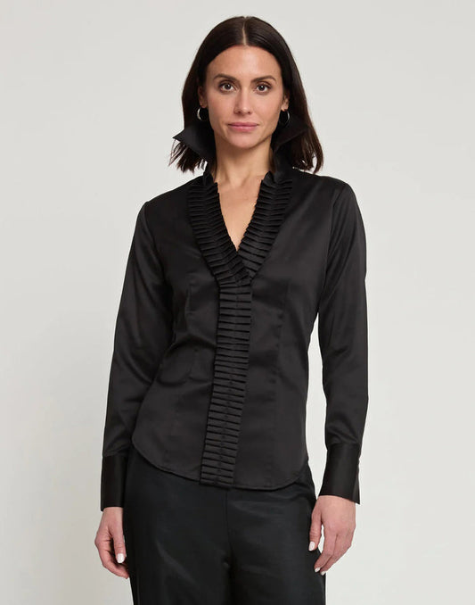 A woman with shoulder-length brown hair wears the HINSON WU Maya Long Sleeve Cotton Satin Shirt in white with pleated detailing on the collar and button placket, standing against a plain light background and looking at the camera.