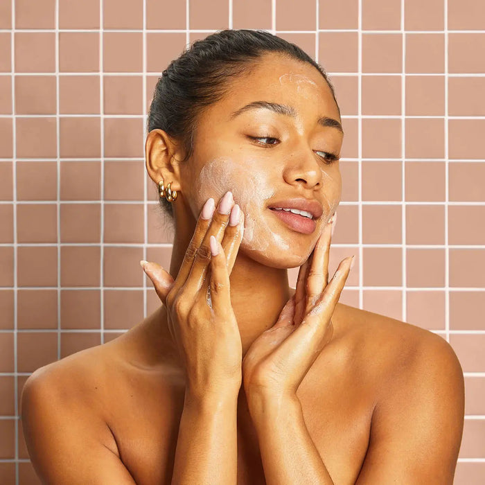 A ribbed, rectangular bar of soap is next to a yellow box labeled "KITSCH - KOJIC ACID FACE AND BODY BAR." It includes turmeric to address dark spots, pigmentation, and uneven skin tone. Net weight: 4 oz.