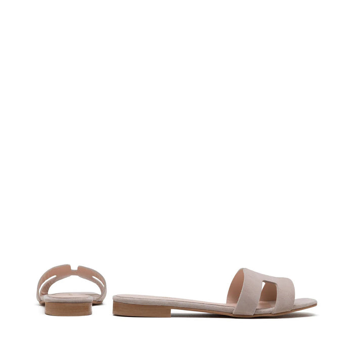 The MICHELE LOPRIORE - H SLIDE is a brown leather sandal with two wide straps, including one with a rectangular cutout, featuring a flat wooden sole. Made in Italy by MICHELE LOPRIORE, it's shown on a white background.