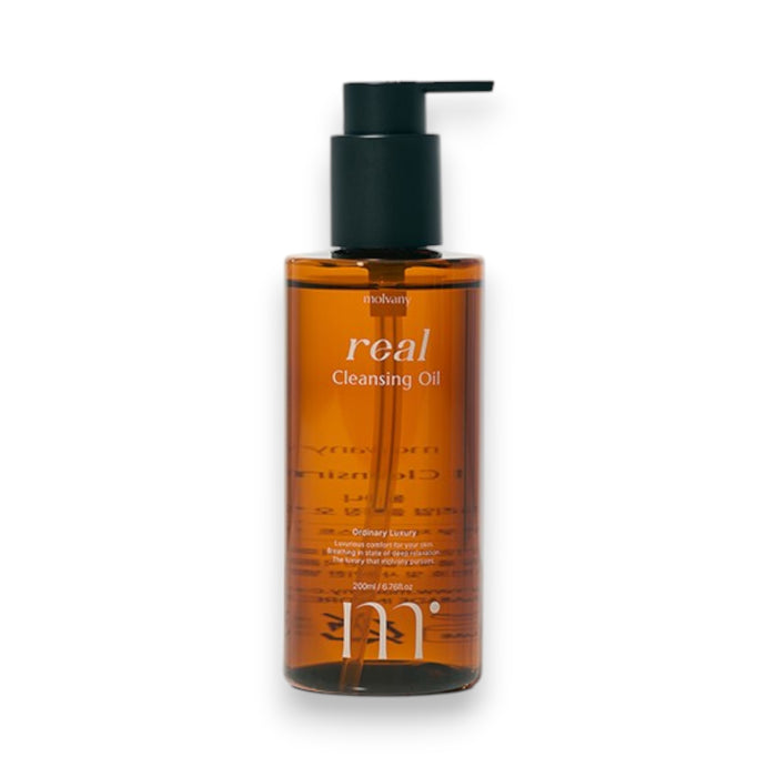A bottle of MOLVANY - REAL CLEANSING OIL by HONG CHEON USA, INC sits on a wet surface. The text reads, "Hydrating Oil Cleansing: Removes makeup while targeting whiteheads and blackheads." An illustration shows oil dissolving dirt from skin pores for effective blackhead removal.