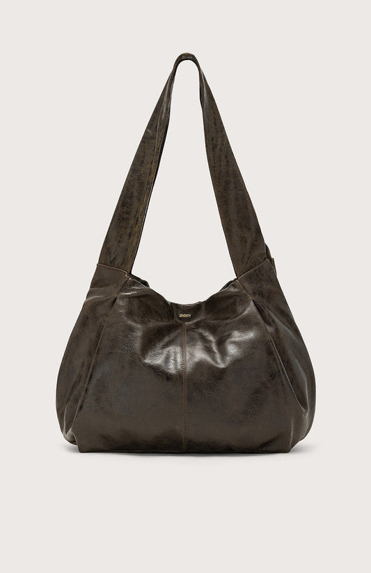 The SEVENTY VENEZIA Slouchy Leather Hobo Bag by SEVENTY features a dark brown, slouchy silhouette in glossy Italian leather with a wide strap, shown against a plain light background.