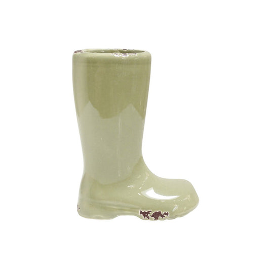 The CREATIVE COOP STONEWARE BOOT VASE (OLIVE) is a small, glossy light green ceramic vase with subtle brown scuffs—perfect as a gardener gift. Photographed on a white background.
