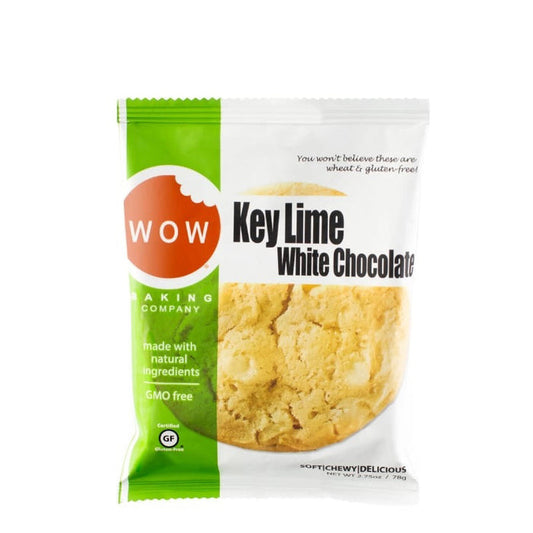 A package of WOW BAKING COMPANY Gluten Free Key Lime White Chocolate Cookie, in green and white, highlights its gluten-free, GMO-free status and natural ingredients, with tart lime and creamy white chocolate visible through the packaging.